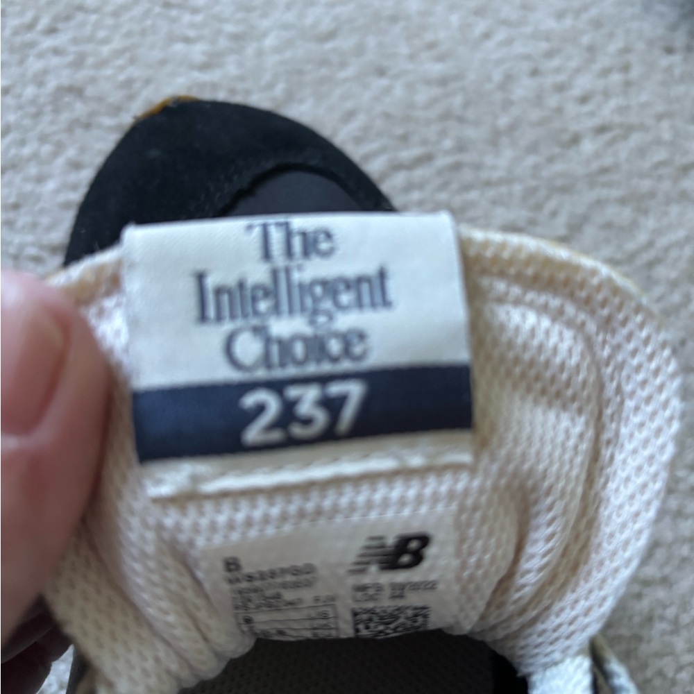 New Balance women’s Black and Cream Sneakers